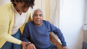 Caregiver assisting an elderly woman with Alzheimer's at home