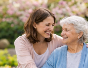 family caregiver helping elderly mother at home reducing stress